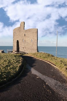 the pathway to the old ruin of a castle in ballybunion