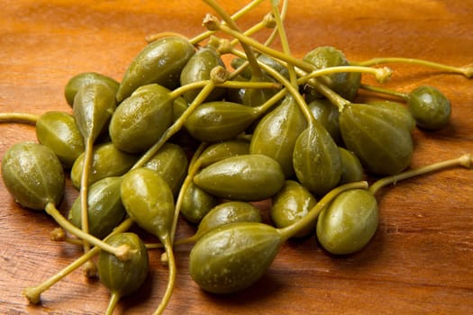 caperberries close up on wood background