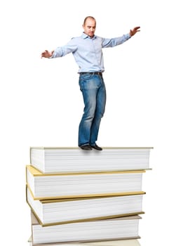 young man try to balance on book pile