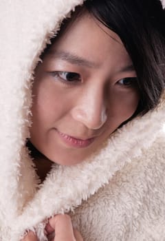 Beautiful young woman in winter outerwear on white