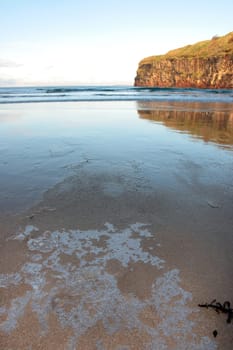 a view of the beach and cliffs in ballybunion co kerry ireland on an icy winters day