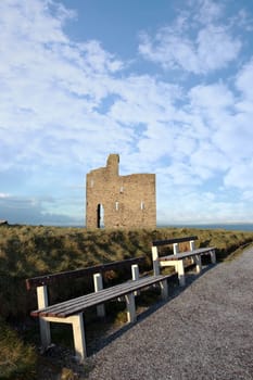 benches with a view of atlantic and castle in ballybunion on a frosty winters day