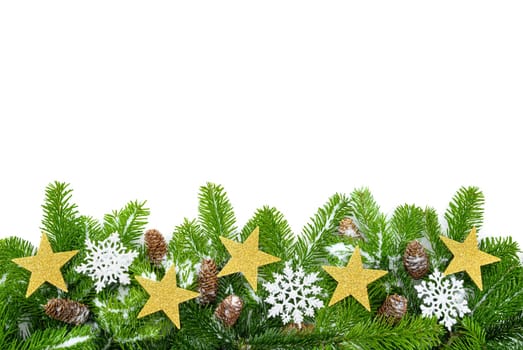 Studio shot of fresh fir branches on white,decorated with stars,cones and snow