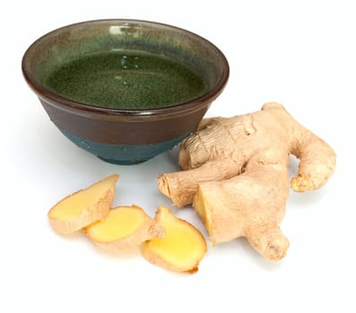 Cup of Tea and Pieces of Ginger on White Background