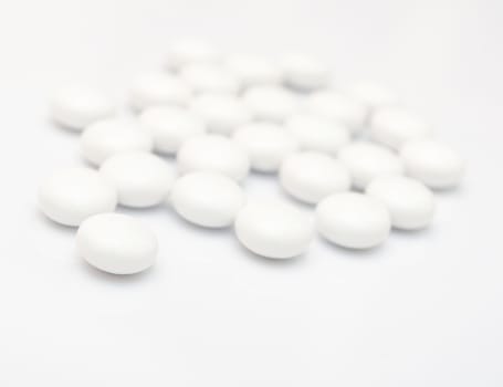 Many White Pills on White Background