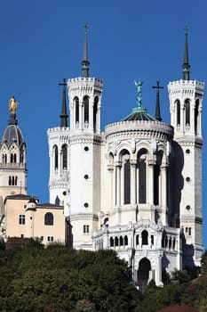 Lyon basilica and statue in the blue sky
