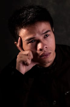 Young Chinese Man seriously thinking about the future