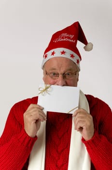 Santa Claus holds a blank card