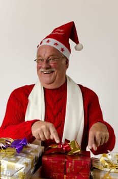 Santa Claus Pointing At Christmas Gifts