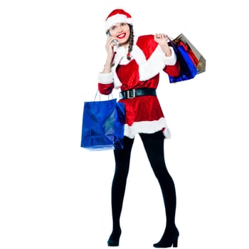 one happy woman dressed as santa claus carrying on the telephone christmas bags  on studio isolated white background