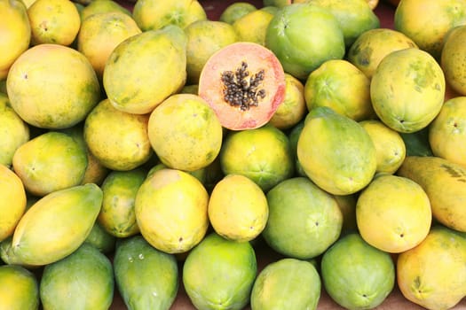 Papaya fruit cut and whole.