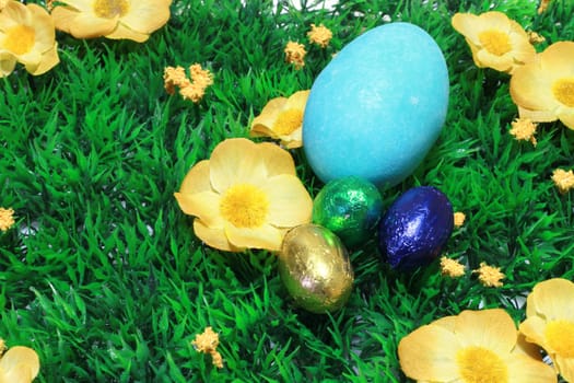 colorful easter eggs in a field of grass