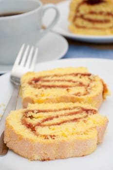 Swiss Sponge Roll With Jam and Coffee on Table