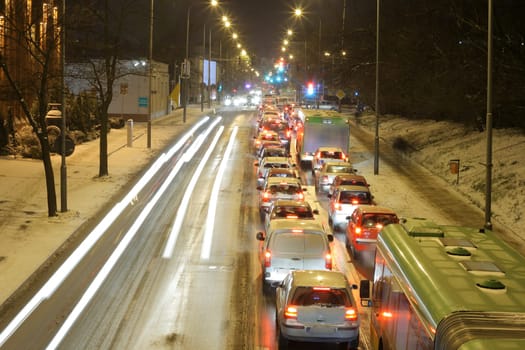 Rush hour traffic lined up car by car on the downtown streets during the evening