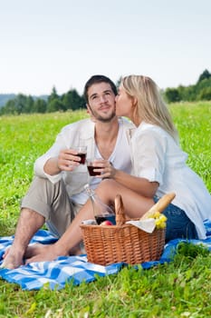 Picnic - Romantic happy couple celebrating with wine in sunny nature