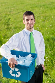 Recycling paper box young businessman handsome in sunny meadow