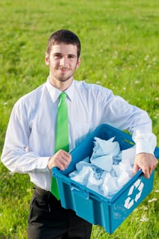 Recycling paper box young businessman handsome in sunny meadow