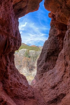 Opening in a red rock cliff face in Sedona, Arizona