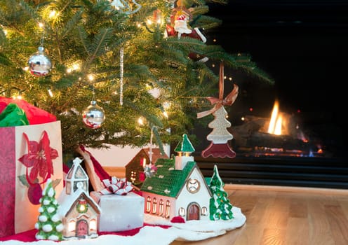 Image of lighted ceramic houses under a Christmas tree