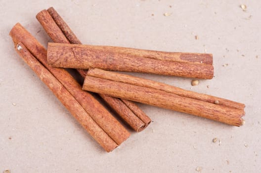 Cinnamon stick closeup on a brown background