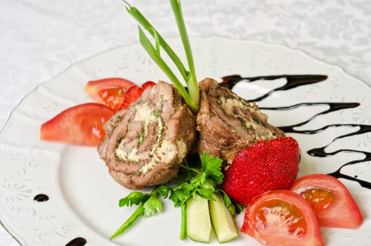 Pork rolls with cheese and vegetables: onion, cucumbers, tomatoes