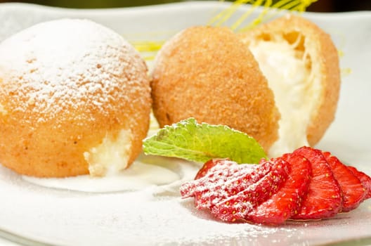 Dessert of ice-cream at biscuit with strawberry and caramel
