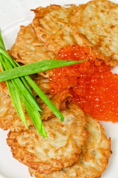 pancakes with red caviar and green onion closeup dish