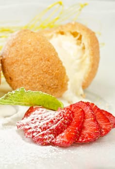 Dessert of ice-cream at biscuit with strawberry and caramel
