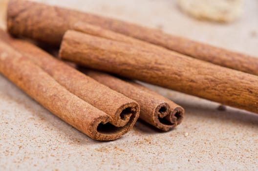 Cinnamon stick closeup on a brown background