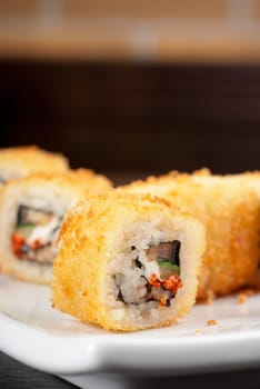 Sushi rolls made of rice, smoked eel, cream cheese and flying fish roe - tobiko caviar