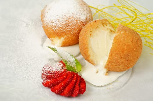 Dessert of ice-cream at biscuit with strawberry and caramel