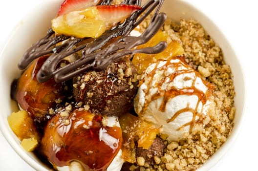 ice cream with chocolate, nuts and caramel close up