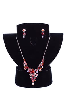 a necklace with pendants and earrings on a white background