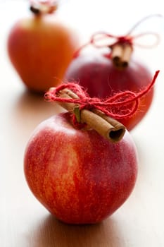 Close-up of delicious red Christmas apples with cinnamon sticks