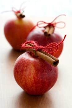 Close-up of delicious red Christmas apples with cinnamon sticks