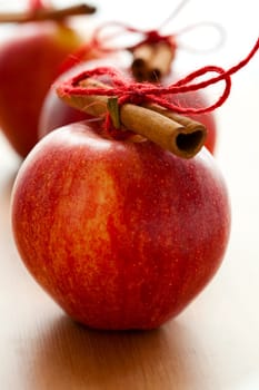 Close-up of delicious red Christmas apples with cinnamon sticks