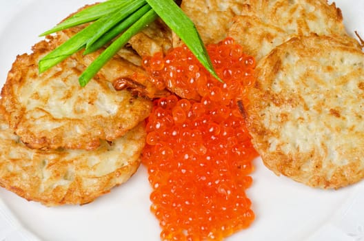 pancakes with red caviar and green onion closeup dish