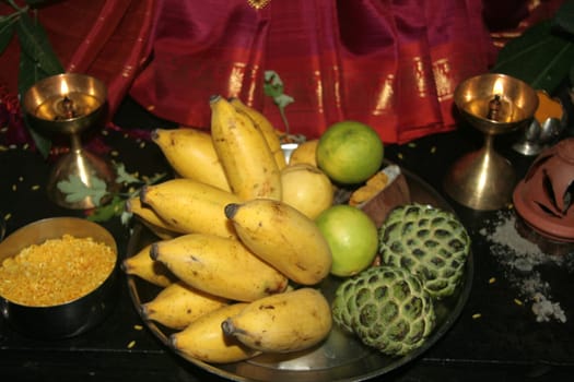 Bowl of fruits in setting of Puja (prayer to God)