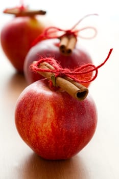 Close-up of delicious red Christmas apples with cinnamon sticks