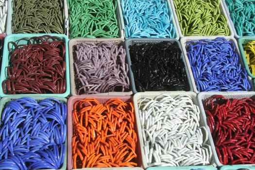 Neatly arranged trays of colourful/colorful glass bangles