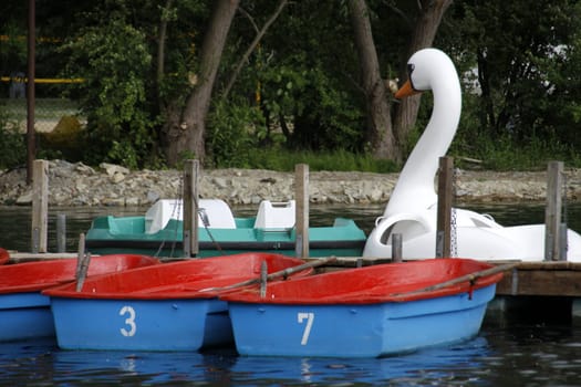 Blue and red rowing boats on a jetty