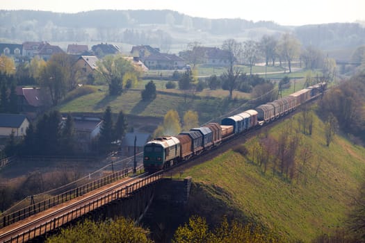 Freight train passing the hilly landscape