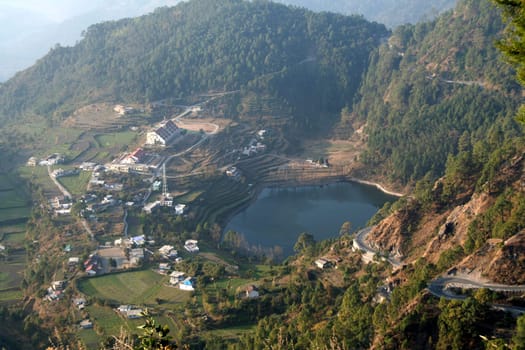 View of lake surrounded by mountains near Nainital, Uttarakhand State, India