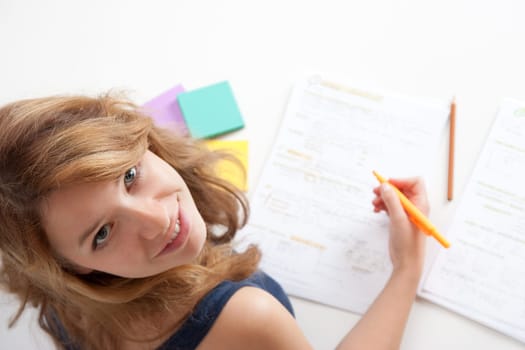 College student studying (swot up) for exam. Focused on face. Top view.