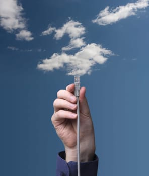 Cloud computing concept. Hand with ethernet cable connecting into cloud.