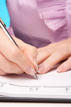 Woman make plans - hand with pen take a note in calendar.