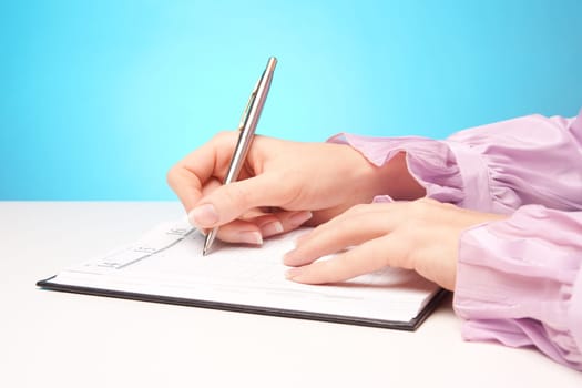 Woman make plans - hand with pen take a note in calendar.