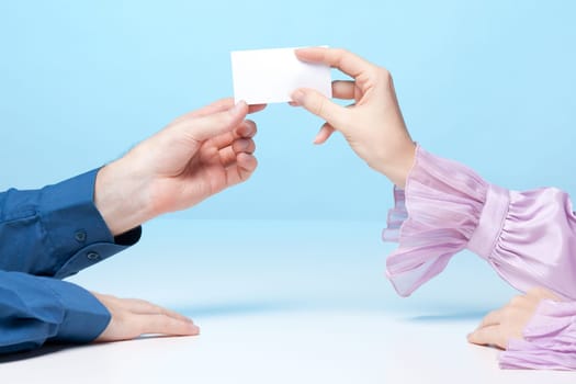 Woman is giving man her business card.