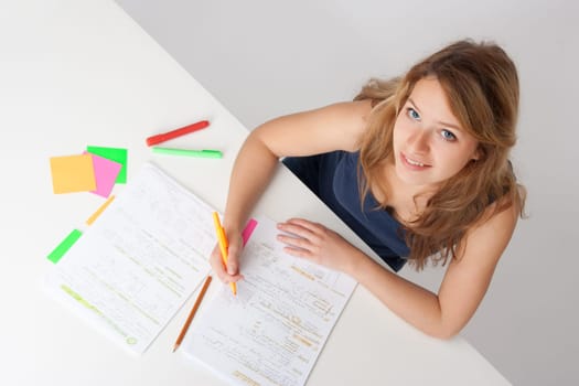 College student studying (swot up) for exam. Focused on face. Top view.