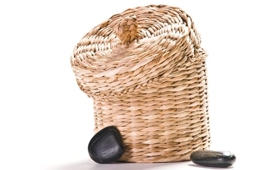 Brown basket with stones isolated on white background